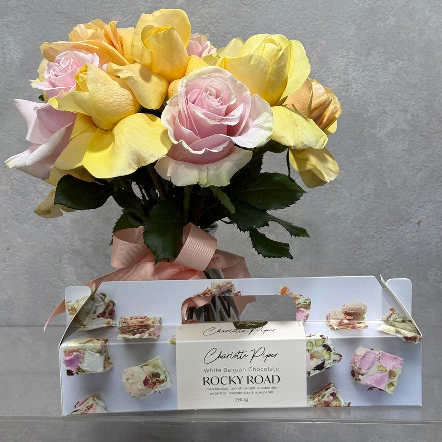 Vase of Soft Yellow and Pink Roses with Rocky Road